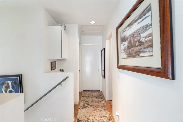 a view of a hallway to rooms and bathroom