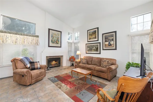 a living room with furniture fireplace and window