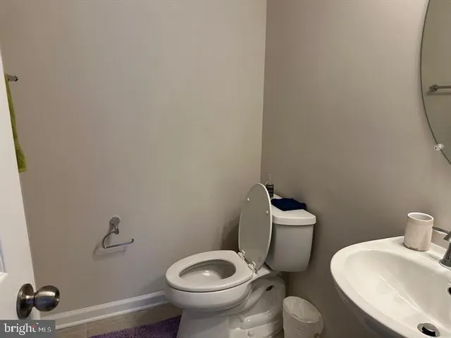 a white toilet sitting next to a bathroom sink