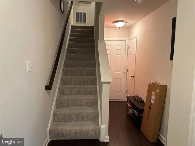 a view of entryway and hall with wooden floor