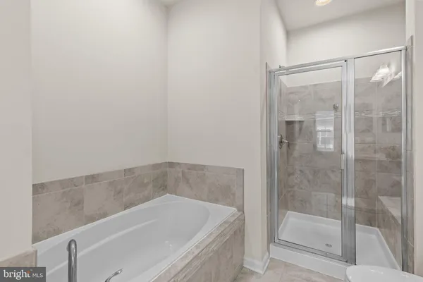 a bath tub sitting next to a shower