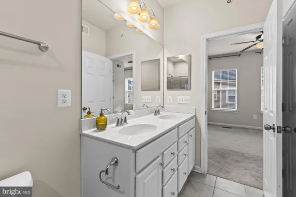 a bathroom with a sink vanity and mirror