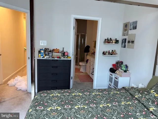 a view of walk in closet with clothes