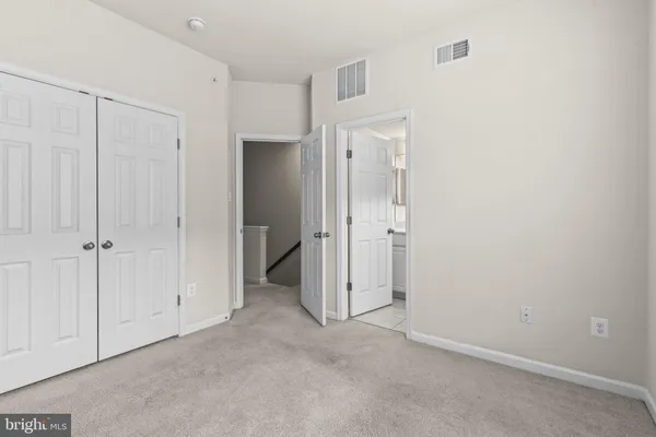 an empty room with closet area