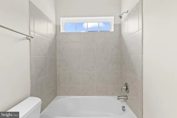 a bathroom with a bathtub and toilet