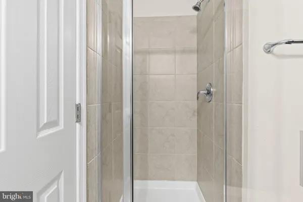 a bathroom with a glass shower door