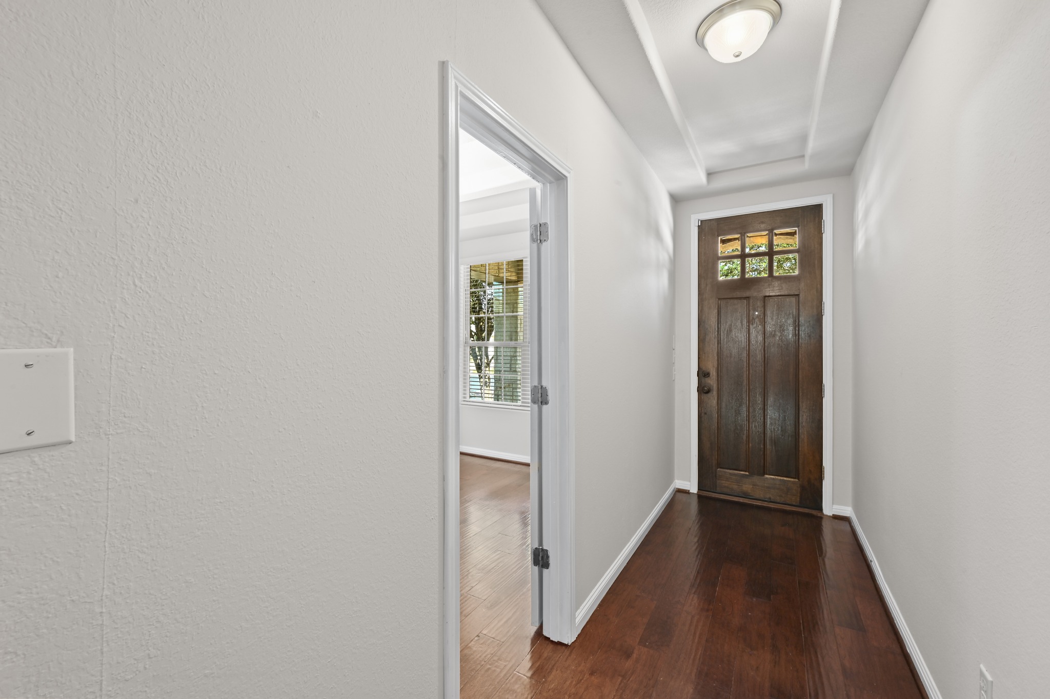 351 Wincliff Drive Buda, TX 78610 - Photo 6 of 40 Rich hardwood floors welcome you into this inviting entry with a charming wood-paneled front door.