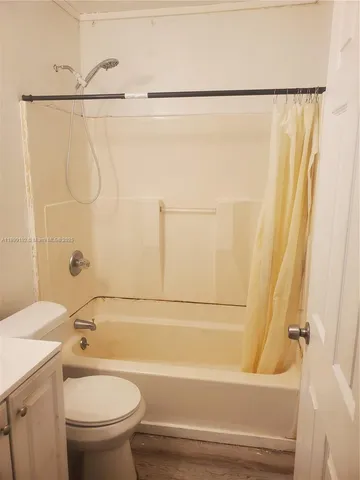 a bathroom with a shower and a toilet