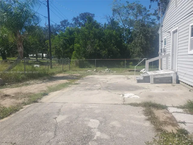 a backyard of a house with lots of green space and fountain