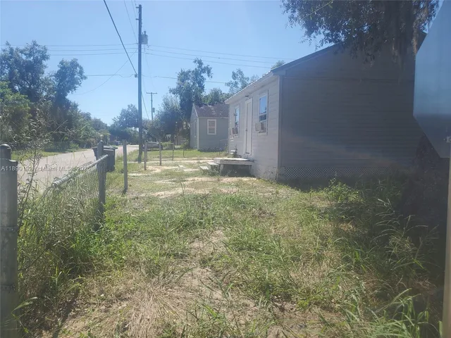 a view of a garden with large trees