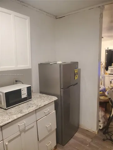 a kitchen with a refrigerator and cabinets