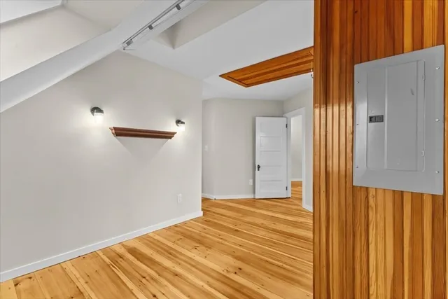 a view of a room with wooden floor