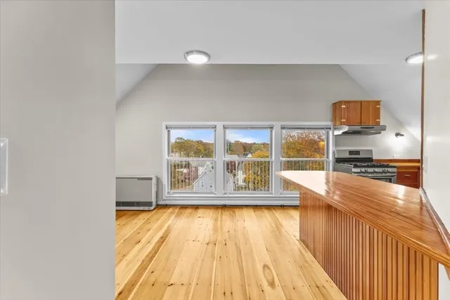 a view of a kitchen with a large window
