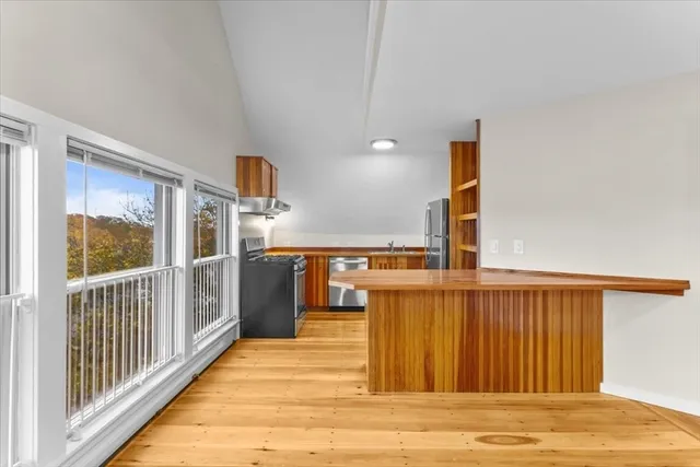 a view of a balcony with wooden floor