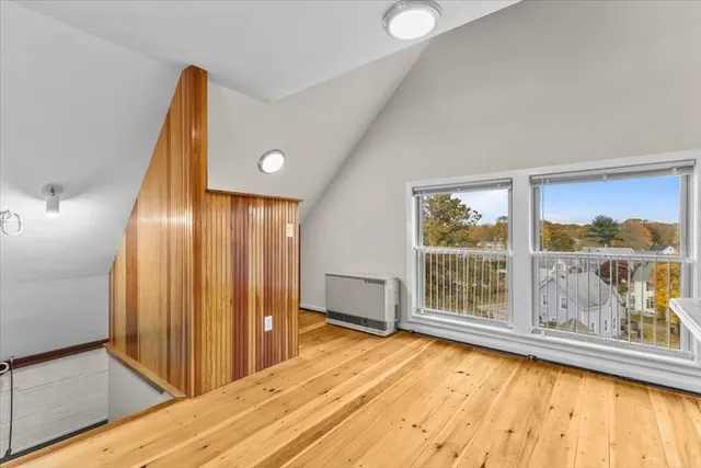 a view of a room with wooden floor and windows