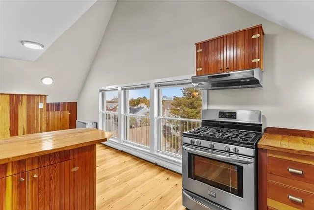 a kitchen with stainless steel appliances granite countertop a stove a sink and a microwave