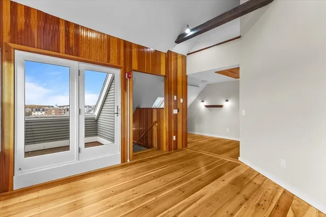 a view of a room with wooden floor