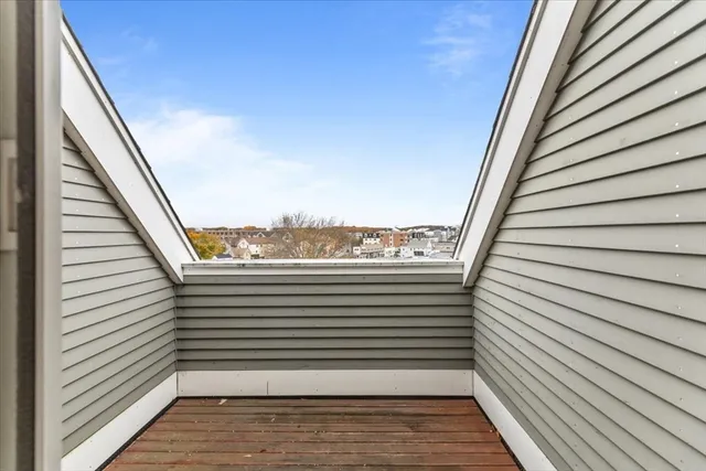 a view of a balcony with wooden floor and fence