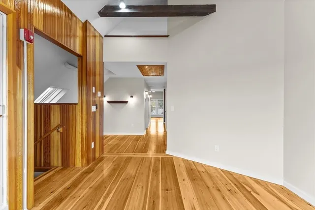 a view of empty room with wooden floor