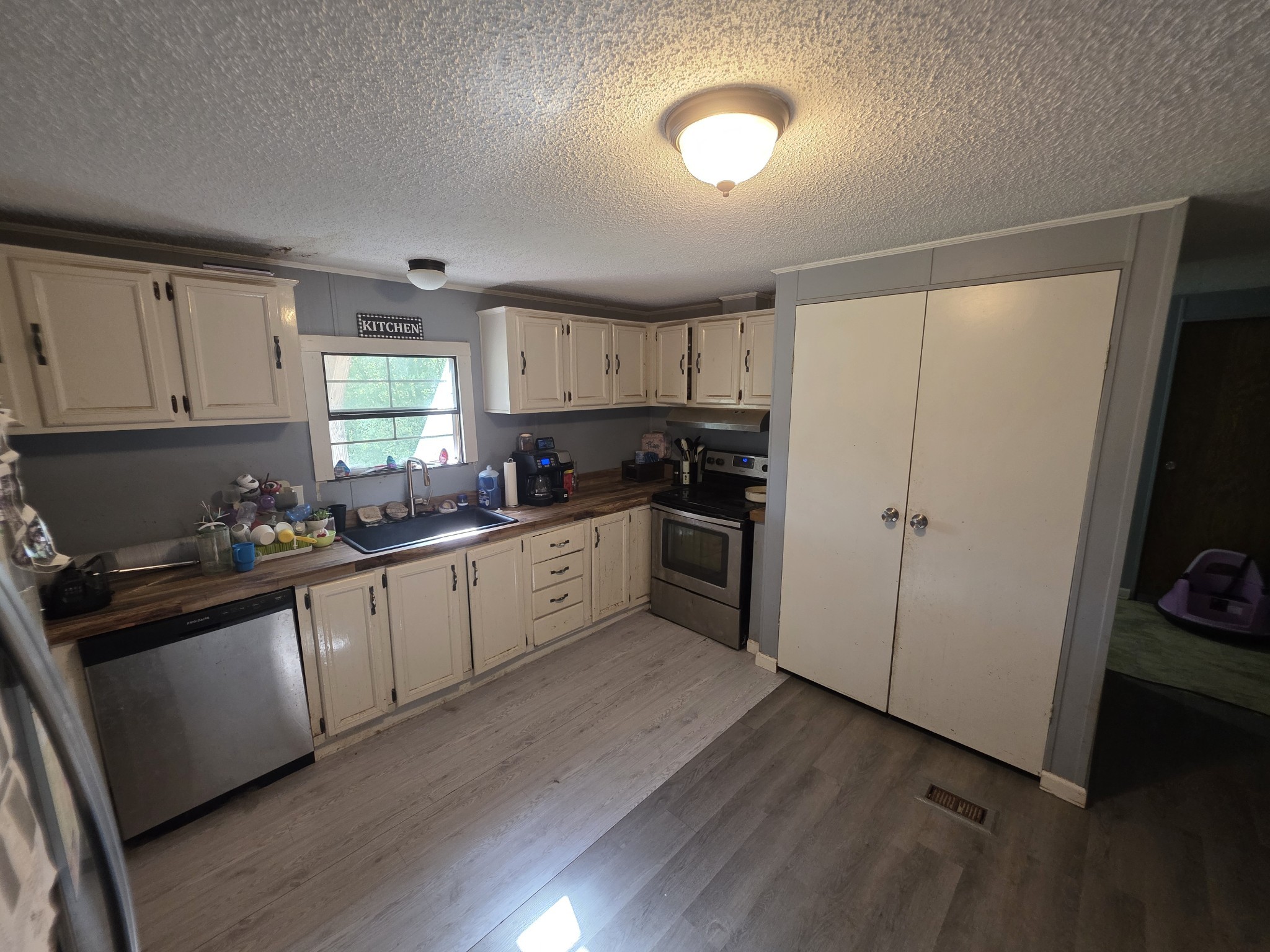 225 Opossum Hollow Road Watertown, TN 37184 - Photo 13 of 29 a kitchen with a refrigerator a sink and cabinets