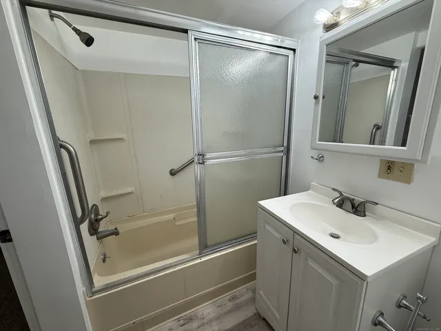 a bathroom with a sink mirror toilet and shower
