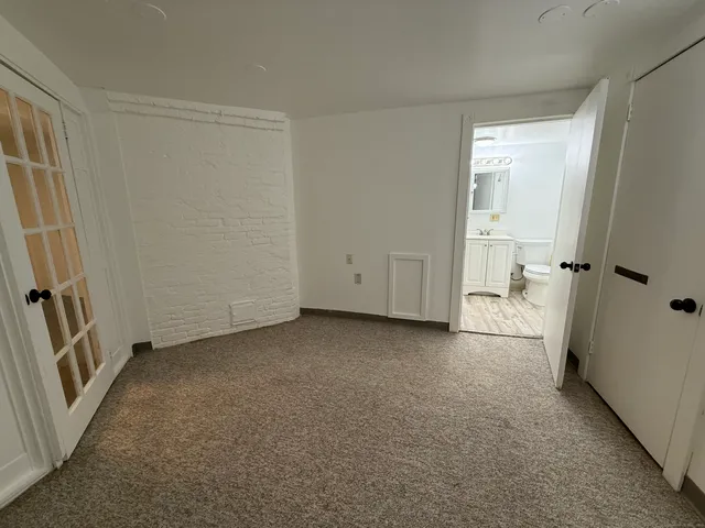 a view of a room with an empty space and a window