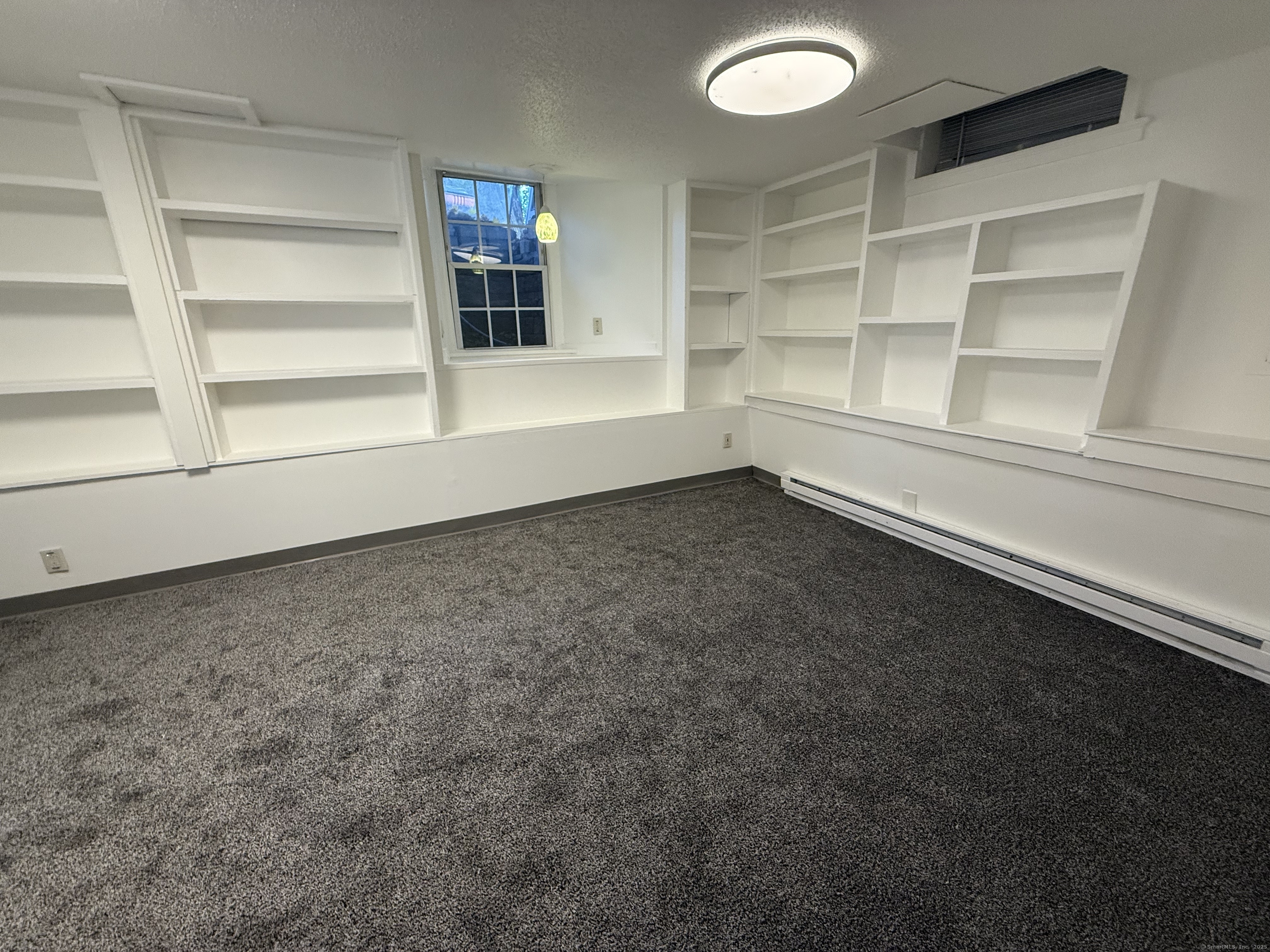 1 1/2 Stetson Street Norwich, CT 06360 - Photo 17 of 29 an empty room with cabinet and windows