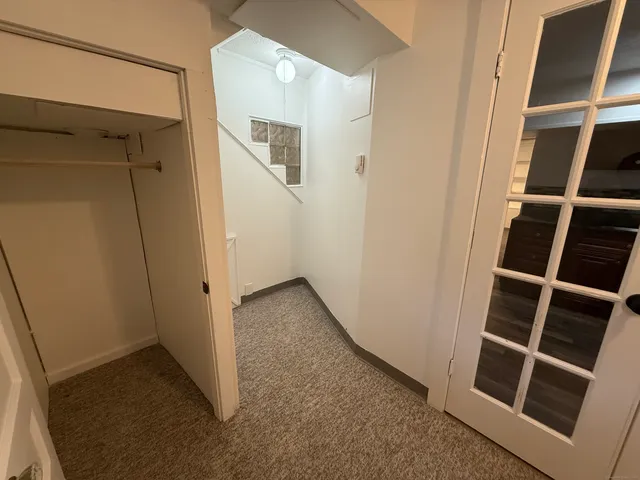 a view of staircase with white walls and a window