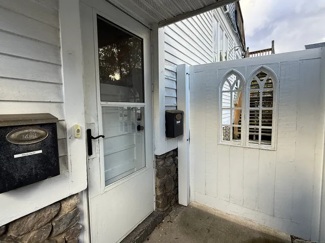 a view of a livingroom with a fireplace and window