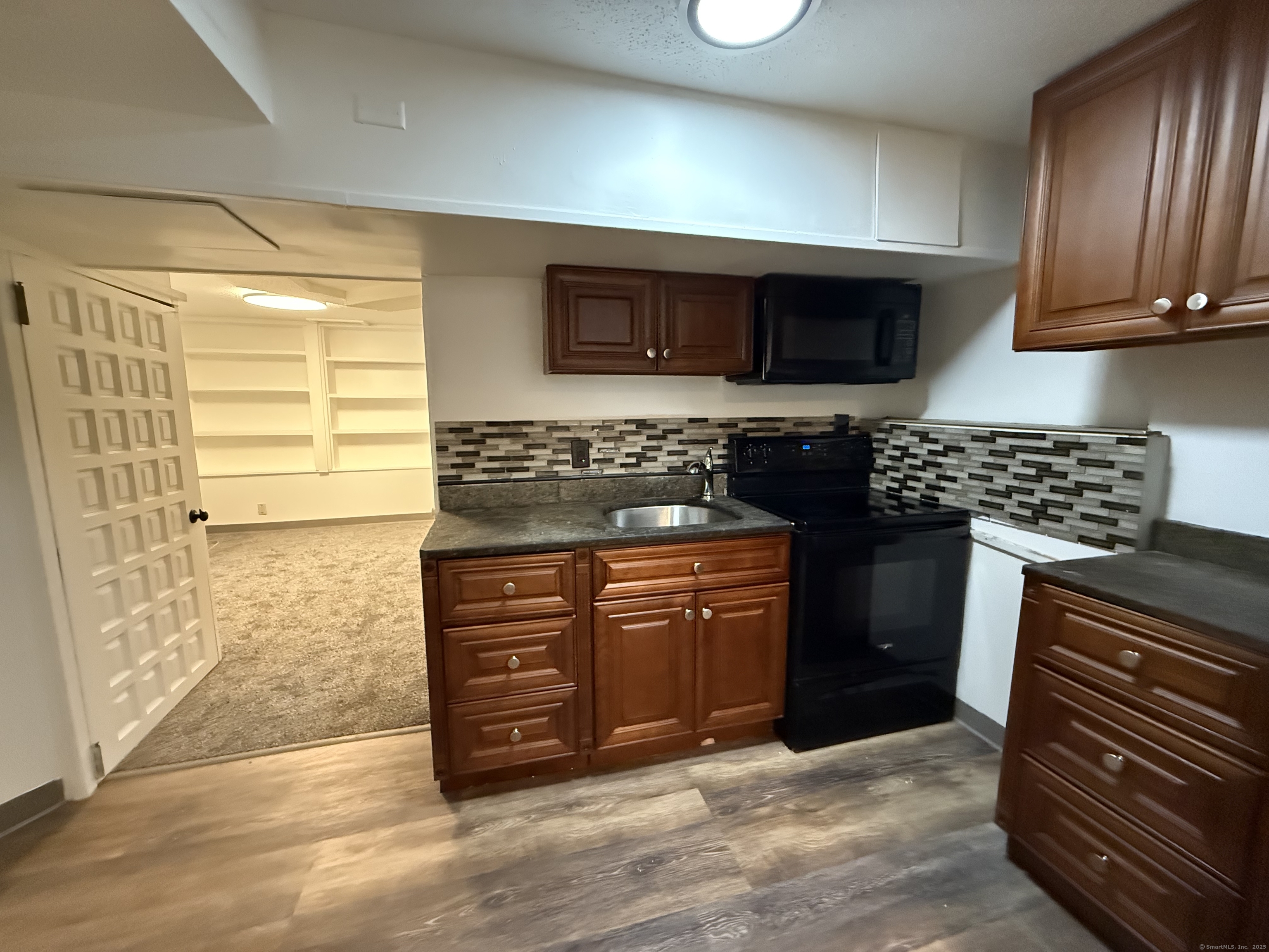 1 1/2 Stetson Street Norwich, CT 06360 - Photo 9 of 29 a kitchen with stainless steel appliances granite countertop a stove a sink and a microwave