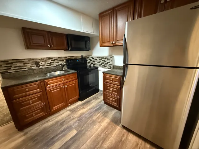 a kitchen with stainless steel appliances a refrigerator stove and microwave