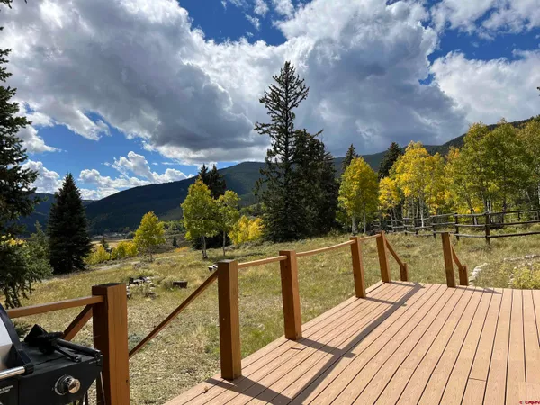 a view of a balcony with wooden floor and lake view