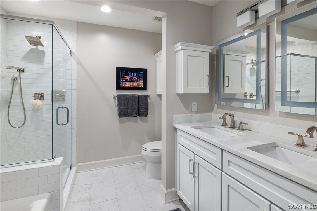 413 Stuart Circle, Unit U5E Richmond, VA 23220 - Photo 13 of 29 a bathroom with a granite countertop sink a toilet and a shower