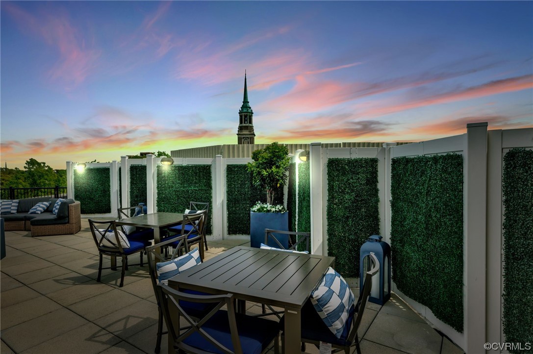 413 Stuart Circle, Unit U5E Richmond, VA 23220 - Photo 15 of 29 a view of a patio with table and chairs and potted plants