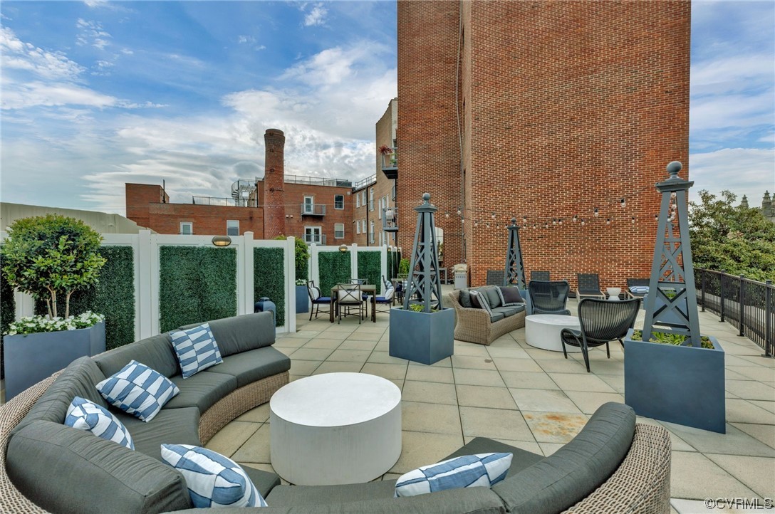 413 Stuart Circle, Unit U5E Richmond, VA 23220 - Photo 20 of 29 a view of a patio with couches and potted plants