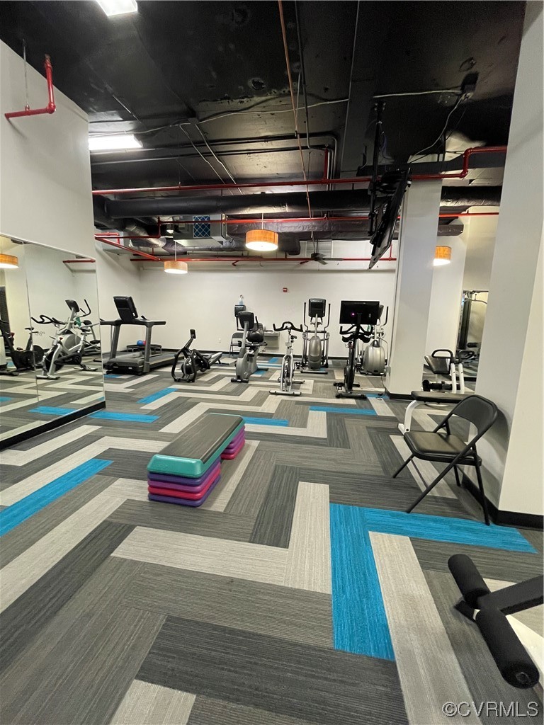 413 Stuart Circle, Unit U5E Richmond, VA 23220 - Photo 25 of 29 a room with lots of wooden furniture and a table