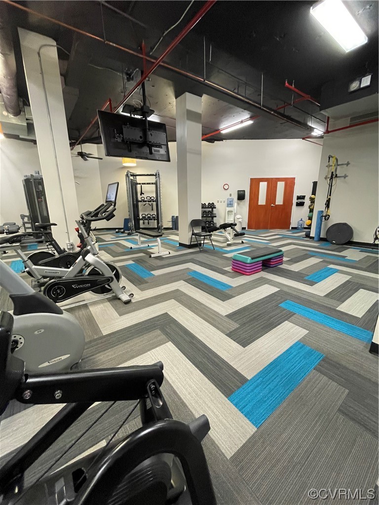413 Stuart Circle, Unit U5E Richmond, VA 23220 - Photo 26 of 29 a view of gym equipment and fire place