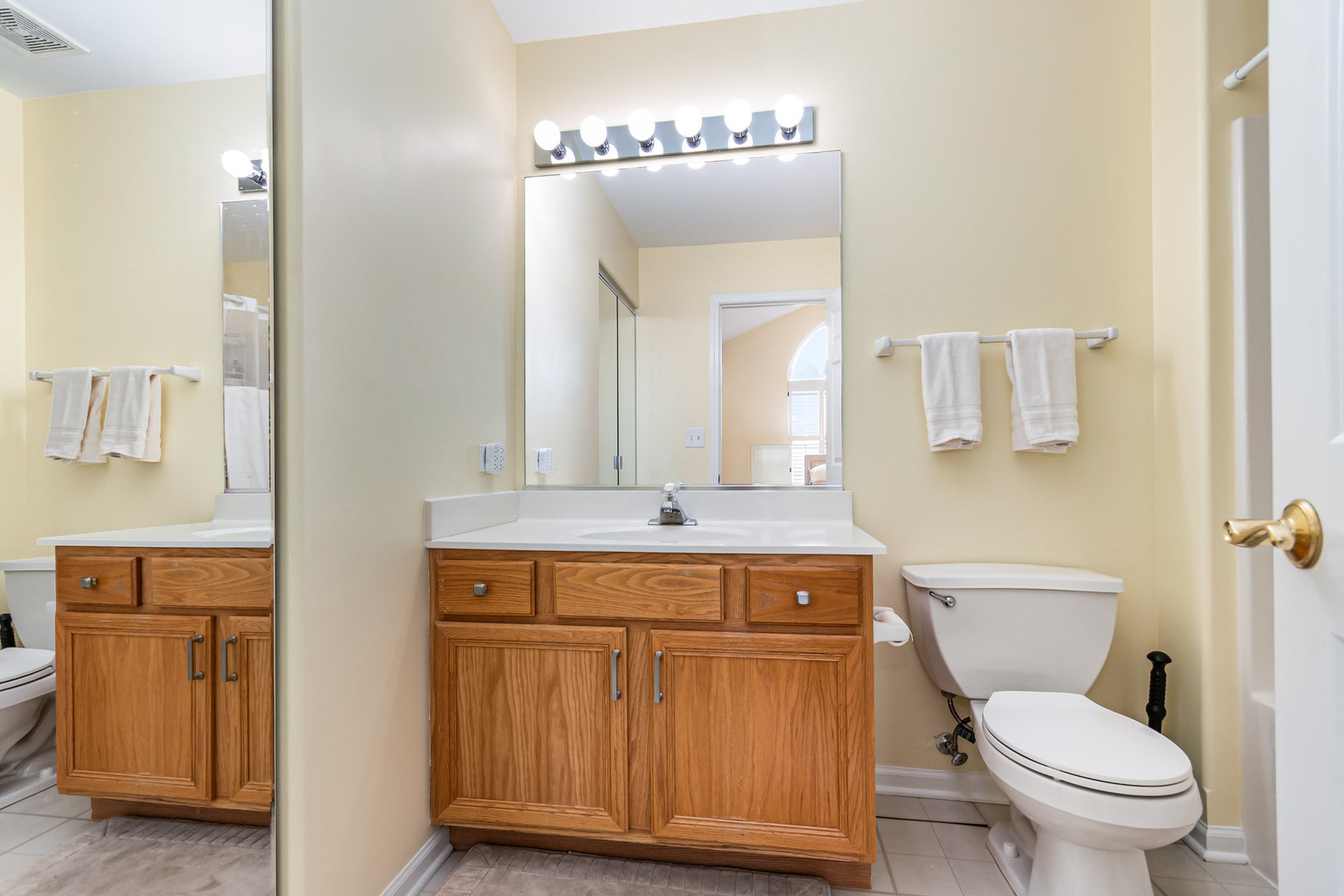 8 Lily Court Bolingbrook, IL 60440 - Photo 14 of 33 a bathroom with a toilet a sink and mirror