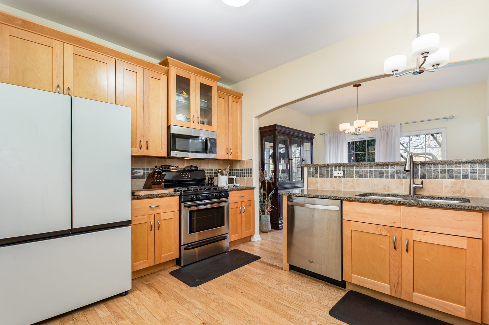 8 Lily Court Bolingbrook, IL 60440 - Photo 7 of 33 a kitchen with stainless steel appliances granite countertop a refrigerator a stove top oven a sink and dishwasher