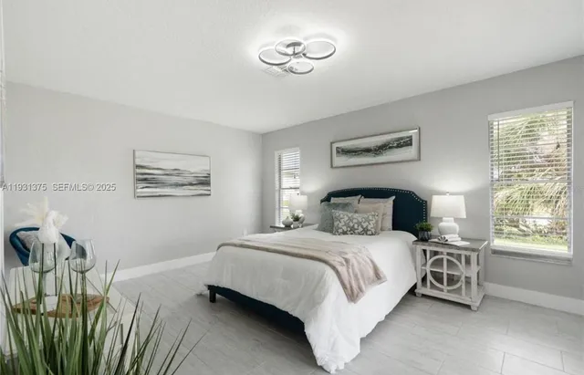 a bedroom with a bed and a chandelier