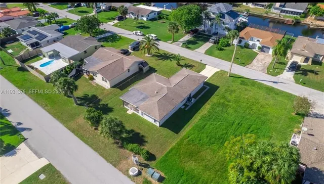 an aerial view of residential houses with outdoor space