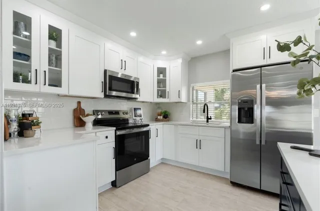 a kitchen with a refrigerator stove and sink