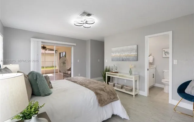 a bedroom with a bed and a table chair