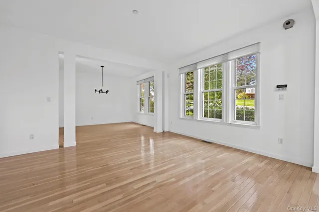 a view of a room with window and wooden floor