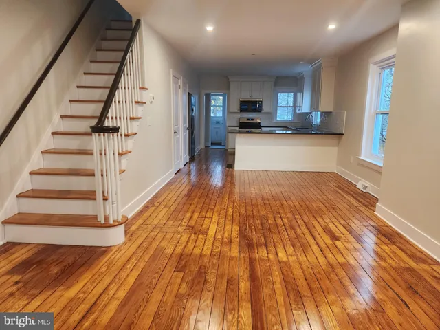a view of a kitchen with wooden floor and electronic appliances
