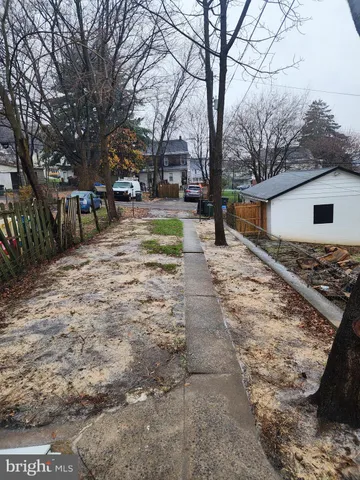 a view of backyard with a large tree