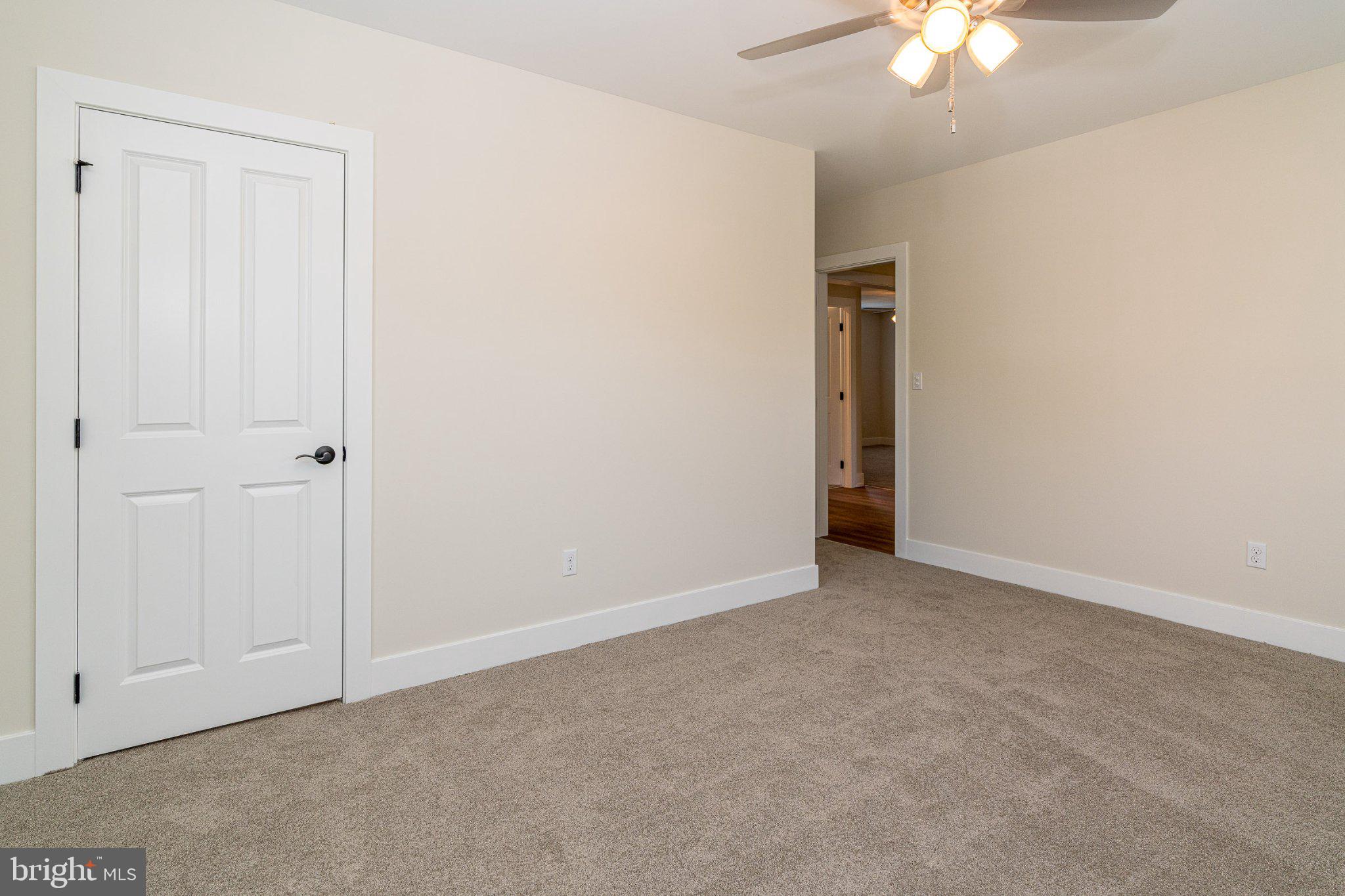 229 North High Street, Unit 3 West Chester, PA 19380 - Photo 16 of 16 an empty room with a chandelier fan