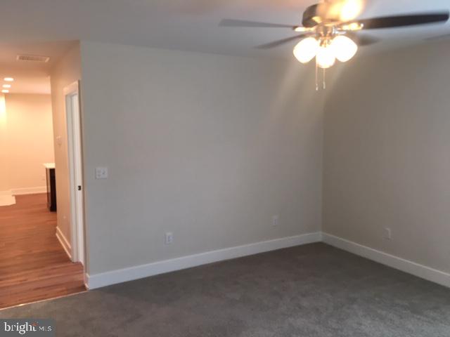 229 North High Street, Unit 3 West Chester, PA 19380 - Photo 7 of 16 en empty room with wooden floor fan and window