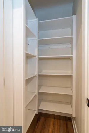 a view of walk in closet with empty racks