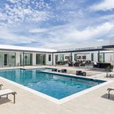 a view of a house with swimming pool and sitting area